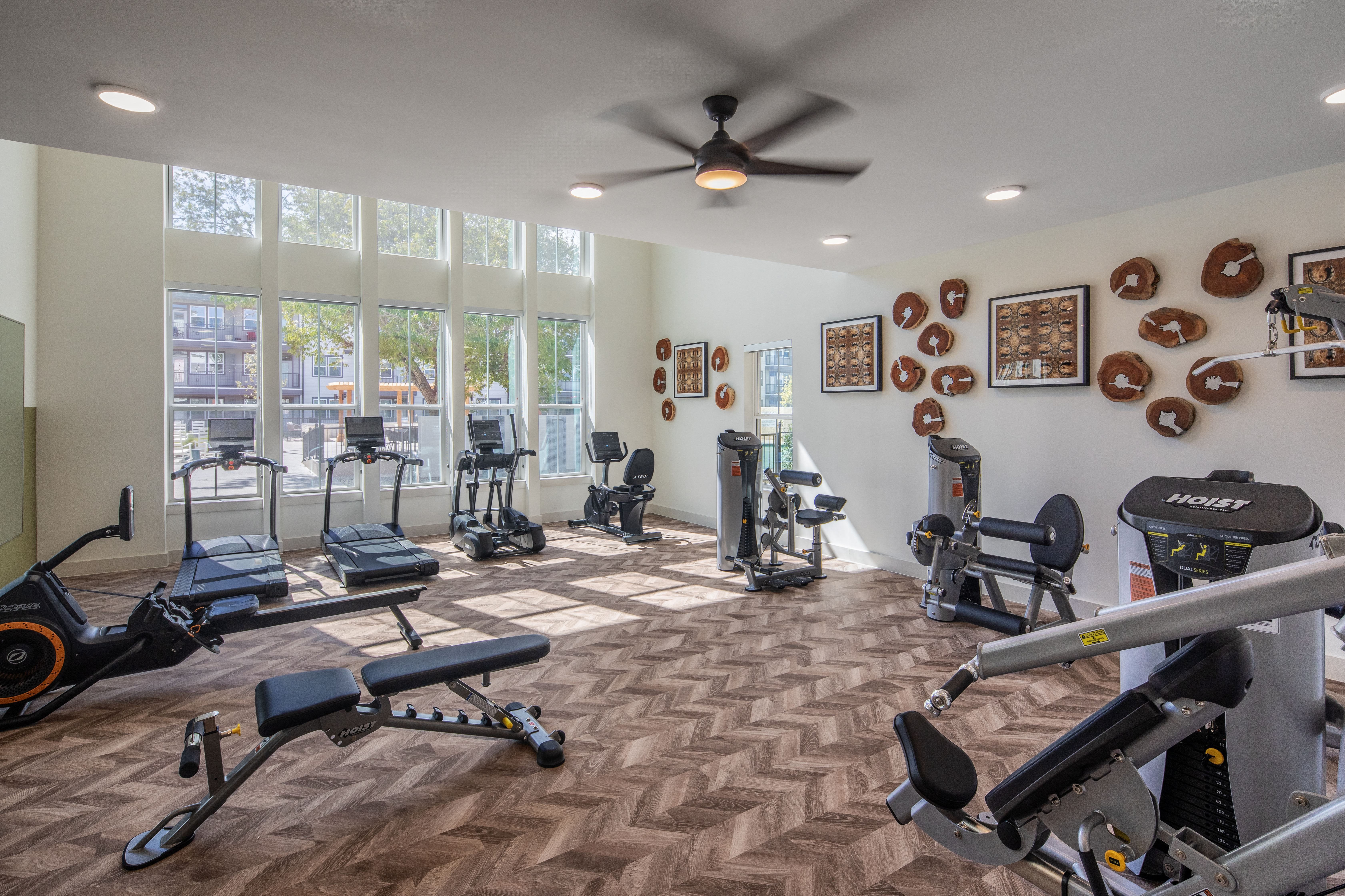a gym with exercise machines and equipment at a senior apartment community